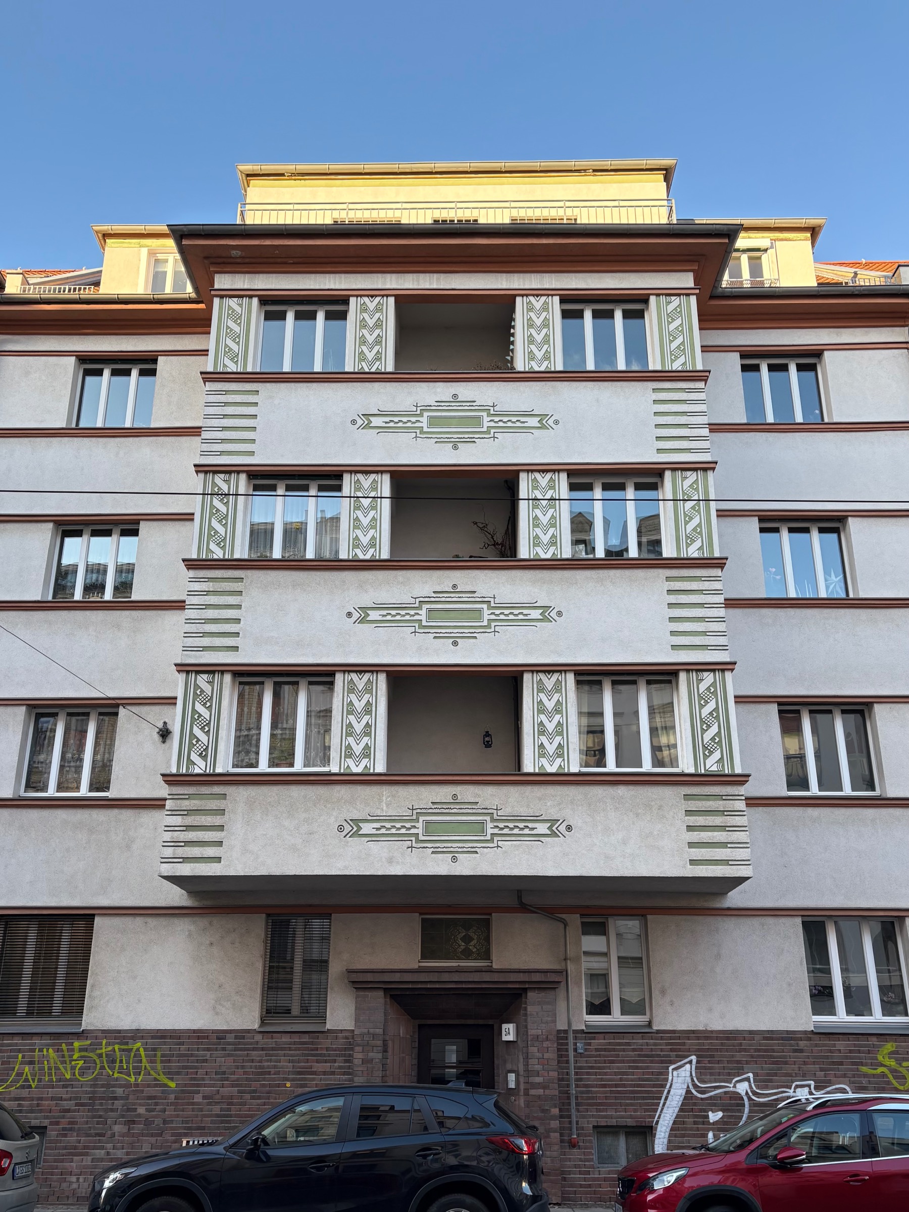 Ornamental sgraffiti on the balconies of an Expressionist building from 1936