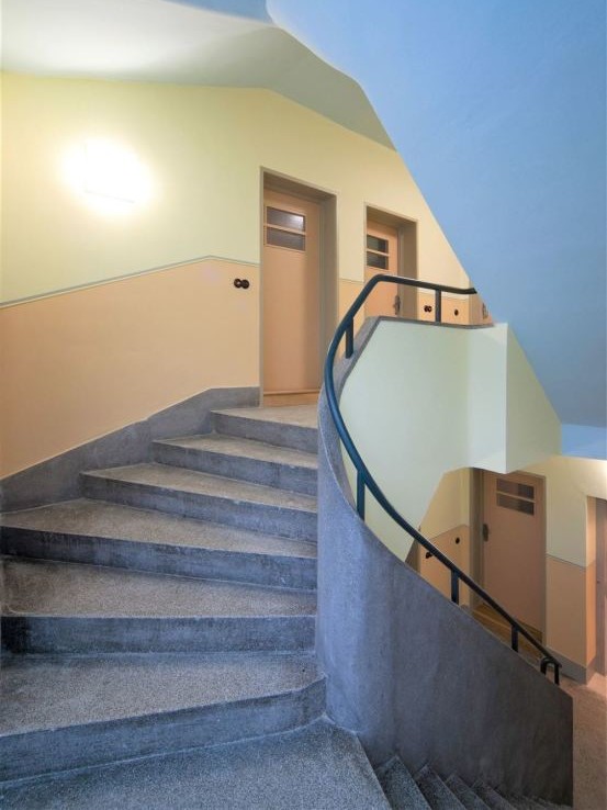 Stairs leading up to bright apartment doors